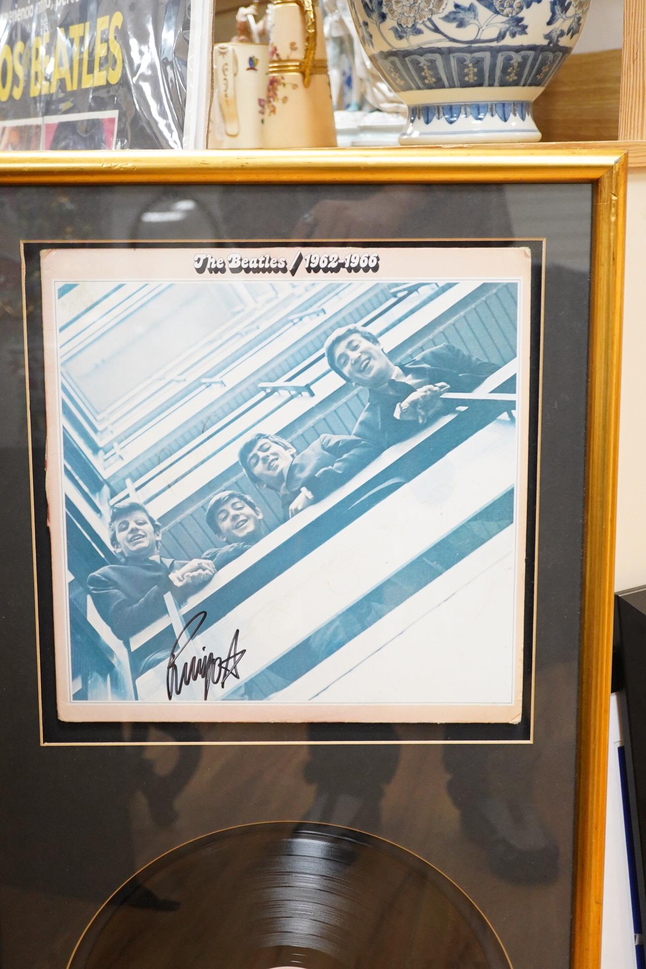 Three framed Beatles autographs; a framed signed album (missing Lennon), 84 x 44cm overall a photograph of Paul McCartney and a photograph of Ringo Starr, both signed across the image
